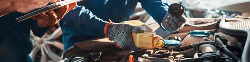 Mechanic Filling Car With Oil 